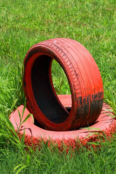 Spare tire on a green grass. — Stock Photo, Image