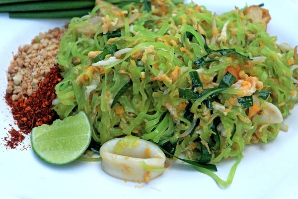 Revuelve los fideos fritos, las líneas verdes ponen los calamares y la carne de cerdo . — Foto de Stock