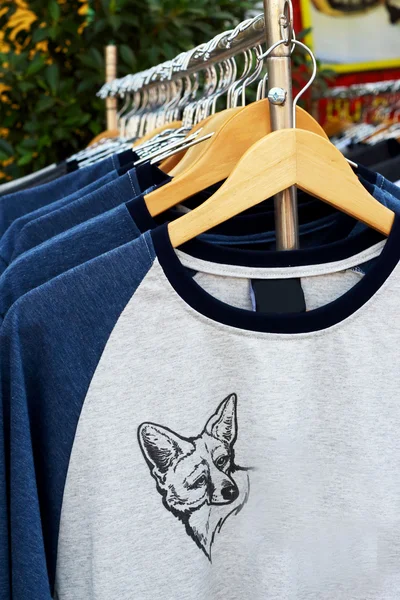 Shop shirts hanging on a rack market — Stock Photo, Image