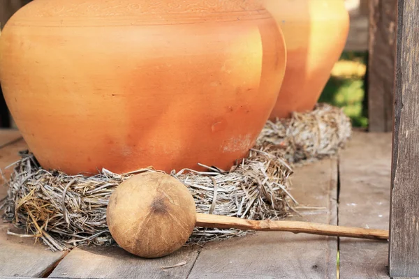 Lerkärl burkar vatten och kokosnöt skal — Stockfoto