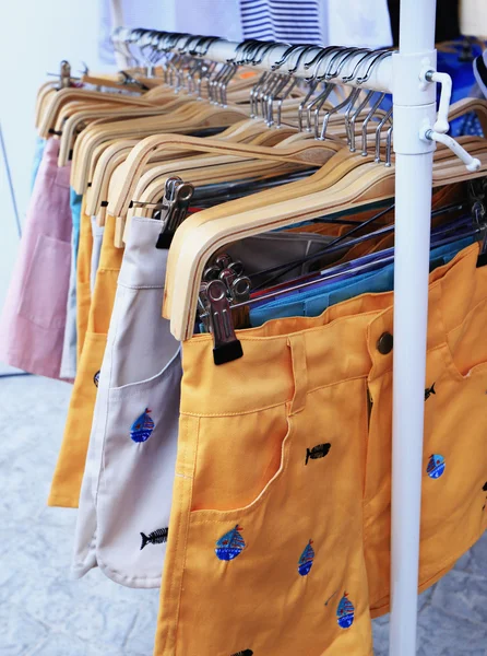 Shop pants hanging on a rack market. — Stock Photo, Image