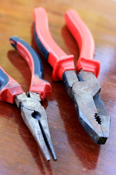 Pliers red handle tool on the wood — Stock Photo, Image