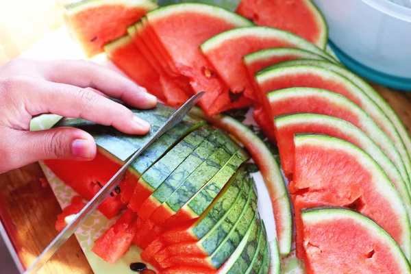 Watermelon fruit sliced pieces on the wooden floor. — Stock Photo, Image