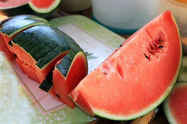 Watermelon fruit sliced pieces on the wooden floor. — Stock Photo, Image