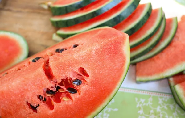 Watermelon fruit sliced pieces on the wooden floor. — Stock Photo, Image