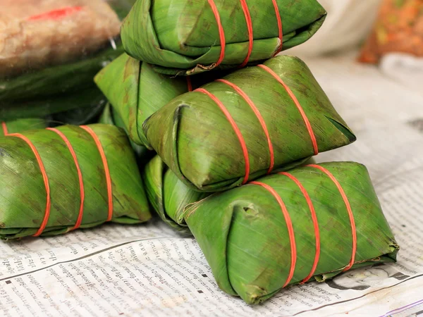 Sausage in banana leaves. — Stock Photo, Image