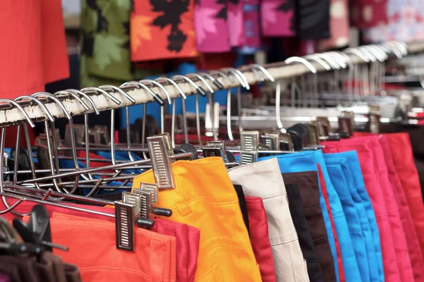 Shop shorts colorful fabric hanging on a rack. — Stock Photo, Image