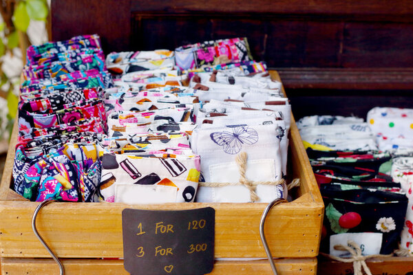 Brightly patterned trousers folded up for sale.