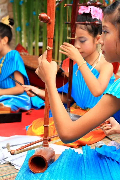 Une fille joue d'un instrument de musique thaïlandais local . — Photo