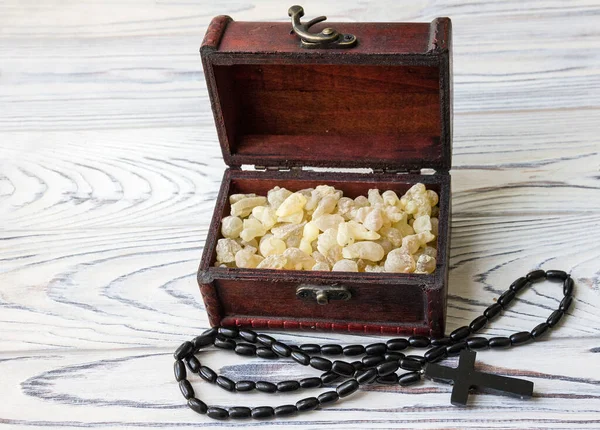 Box with natural incense and agate beads with Christian cross.