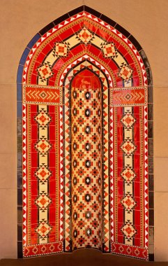 Red mosaic ornament decoration background, Eastern ethnic oriental texture. Muscat, Oman. Sultan Qaboos Grand Mosque.