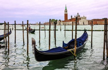 Venice, Italy - May 25, 2022: Gondola on Grand canal. Saint George church (San Georgio basilica) island view.