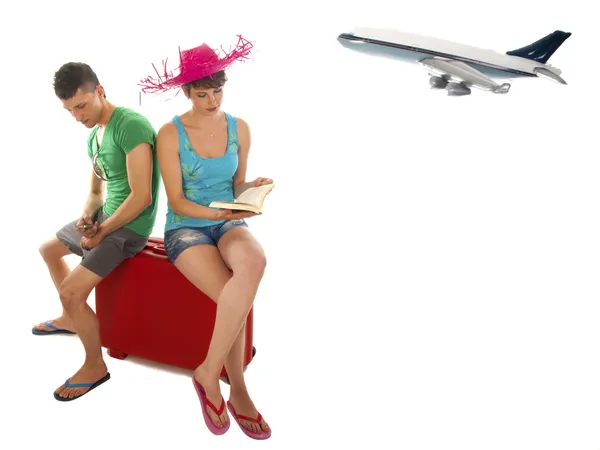 Young couple with suitcase waiting for delayed passenger plane — Stock Photo, Image