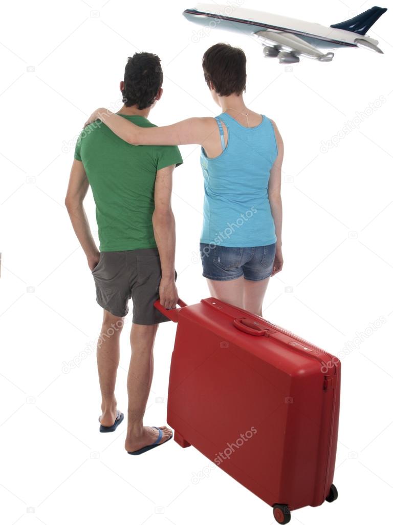 Young couple with suitcase waiting for delayed passenger plane