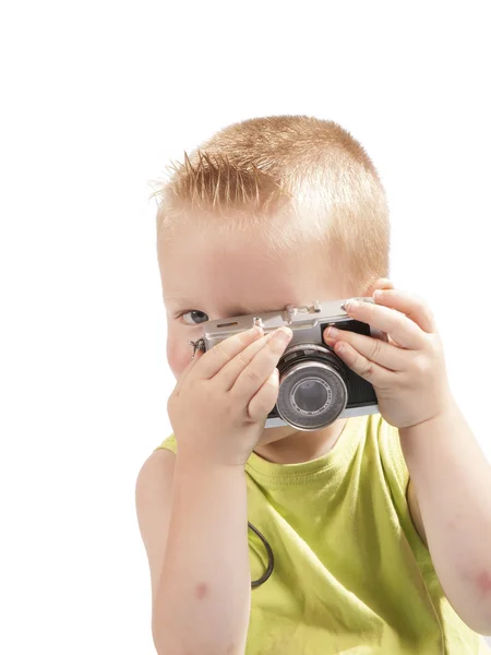 Criança com uma câmera de fotos em um fundo branco — Fotografia de Stock