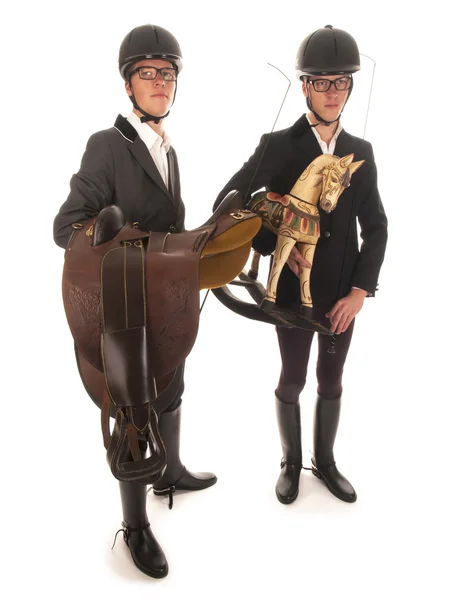 Dos jóvenes guapos con traje de caballo y un caballo mecedora —  Fotos de Stock