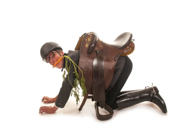 Young man with horses clothes and a carrot in mouth — Stock Photo, Image