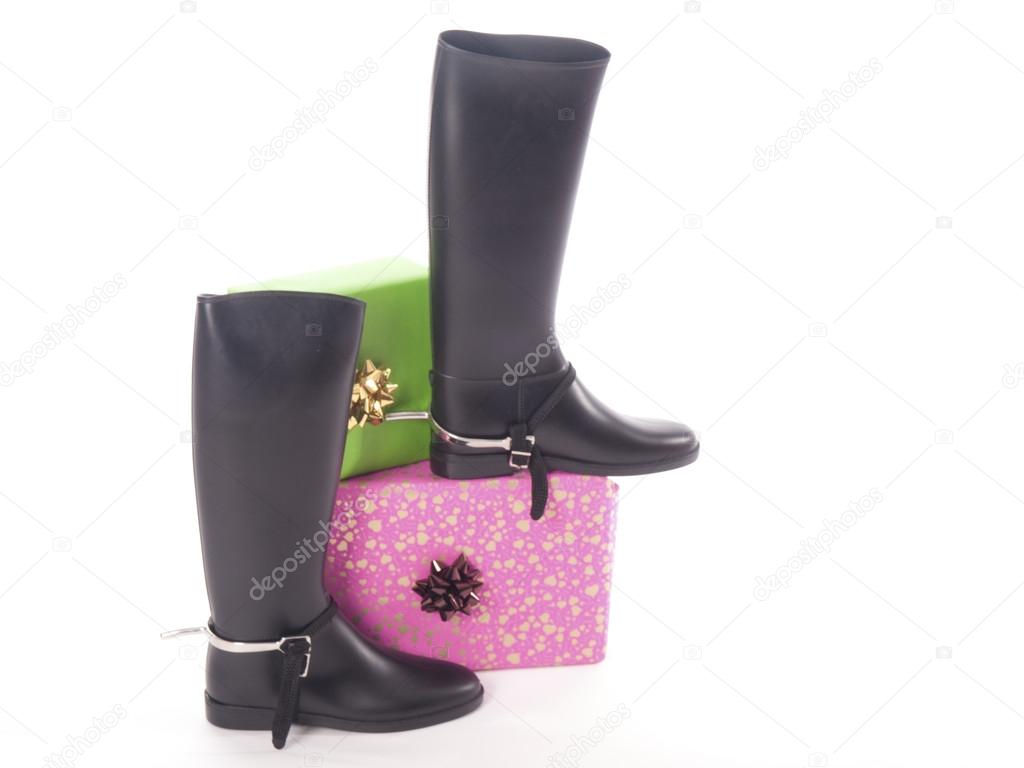 Riding boots and gifts with a white background
