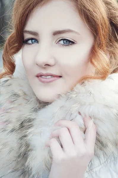 Beautiful redheaded woman in fur coat — Stock Photo, Image
