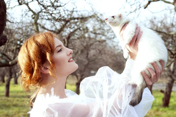 Chica sosteniendo un hurón blanco — Foto de Stock