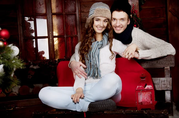 Young couple decorating Christmas tree — Stock Photo, Image