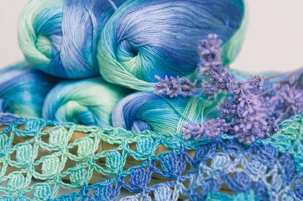 Crocheting in blue and green tones and skeins piled together — Stock Photo, Image