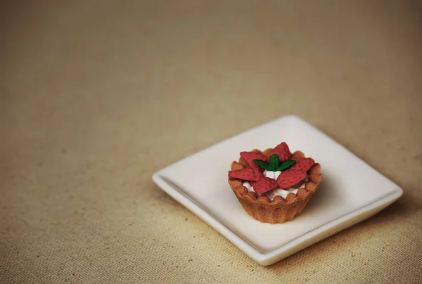 Strawberry tartlet food model still life on a white plate