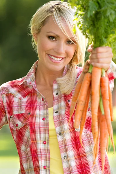 Blonde Farm Girl Displaying Carrots — Stock Photo, Image