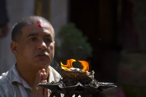 Nepalese brahman man making offering to hindu god — Stock Photo, Image