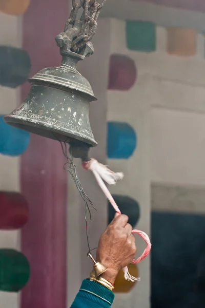 Ringing traditional buddhist bell in nepali temple — Stock Photo, Image