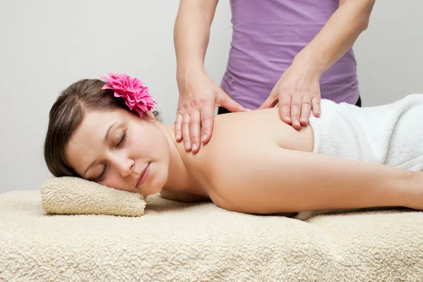 Young woman receiving back massage at spa — Stock Photo, Image