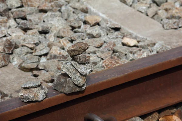 A stack of granite rocks on old railway tracks — Stock Photo, Image