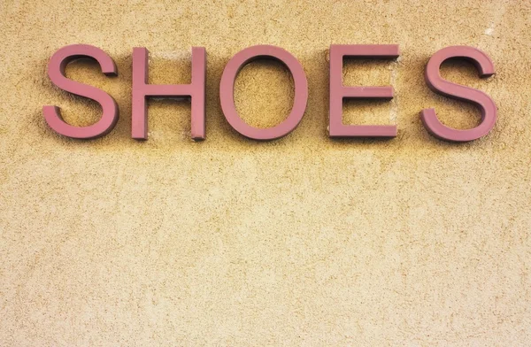 Schuhe Schild an der Wand — Stockfoto