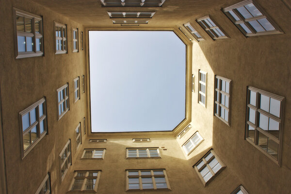 Old building windows tunnel looking up the sky