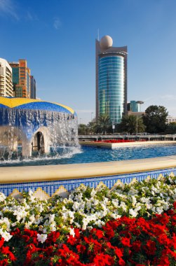 Architecture, flowers, water make a perfect picture of Abu Dhabi clipart