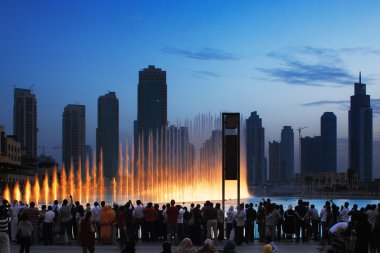 One of UAE's most famous attraction is the Dubai Fountain, crowds gather every hour to watch the water dance clipart