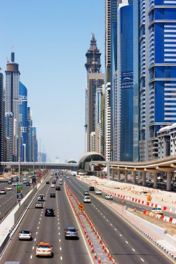 Sheikh Zayed Road is graced with skyscrapers and intense traffic clipart