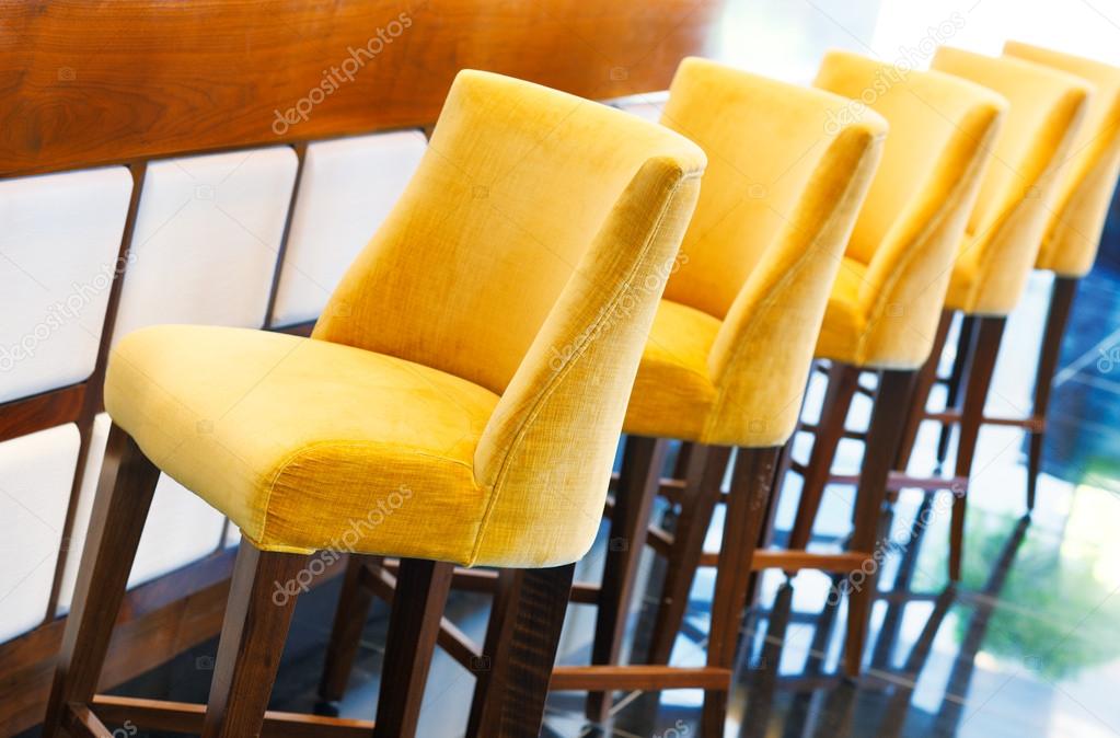 The warm yellow bar stools