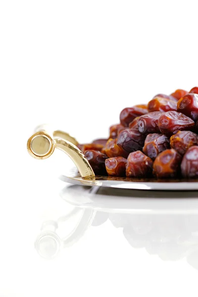 Dried Arabic dates presented on an ornate tra — Stock Photo, Image