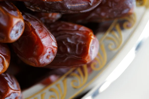 Dried Arabic dates presented on an ornate tra — Stock Photo, Image