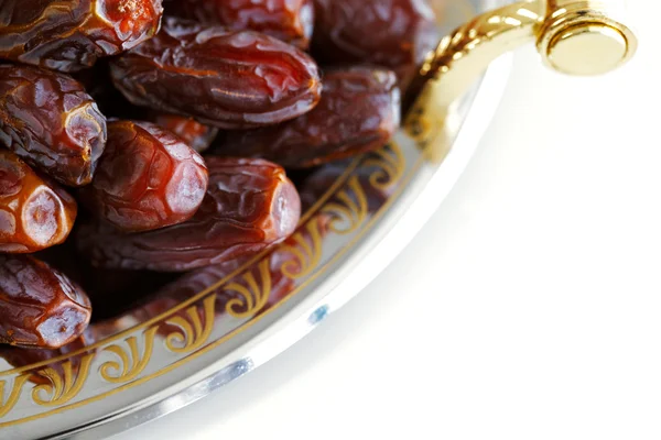 Dried Arabic dates presented on an ornate tra — Stock Photo, Image