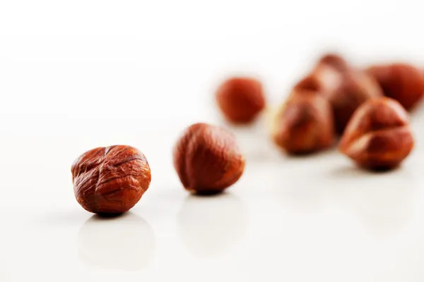 A bowl of hazelnuts on a white background — Stock Photo, Image