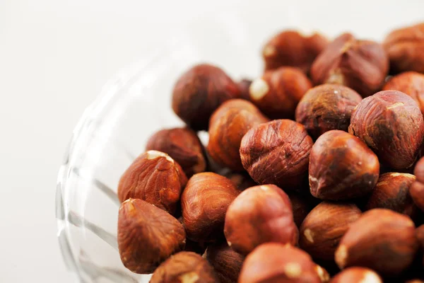 A bowl of hazelnuts on a white background — Stock Photo, Image