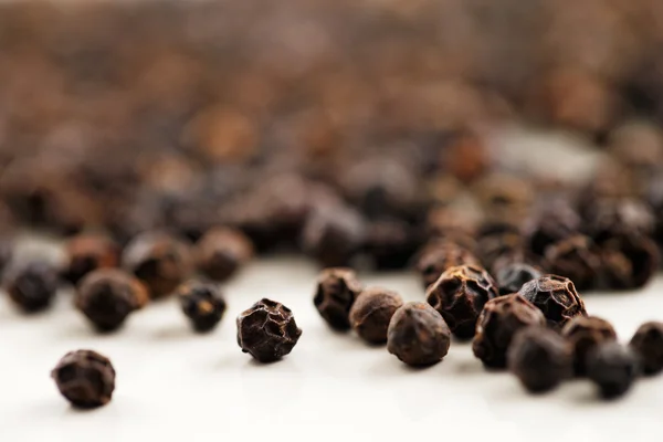 A macro image of black peppercorns — Stock Photo, Image