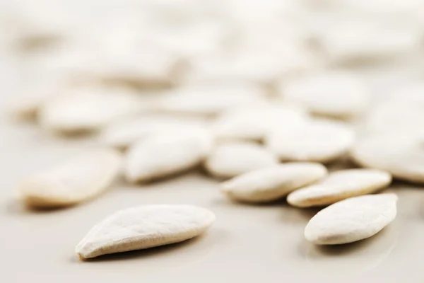 Organic white pumpkin seeds shot in an abstract manner — Stock Photo, Image