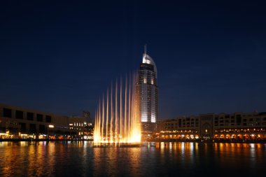 The Dubai Fountain performs and dances to the beat of the music clipart