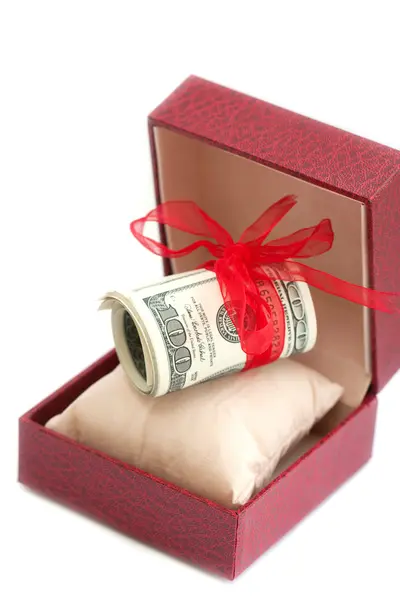 Dollars laying in red decorated gift box, isolated on a white — Stock Photo, Image