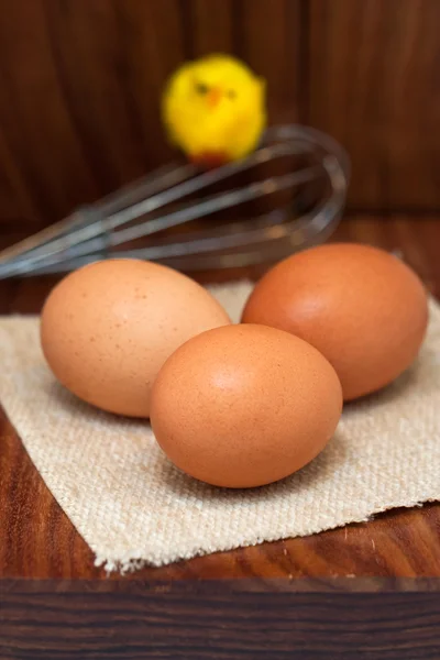 Eggs and chicken on wooden board — Stock Photo, Image