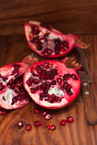 Pomegranate on wooden board — Stock Photo, Image
