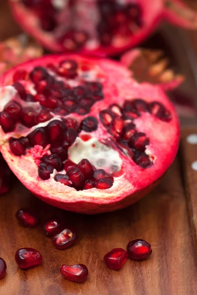 Pomegranate on wooden board — Stock Photo, Image